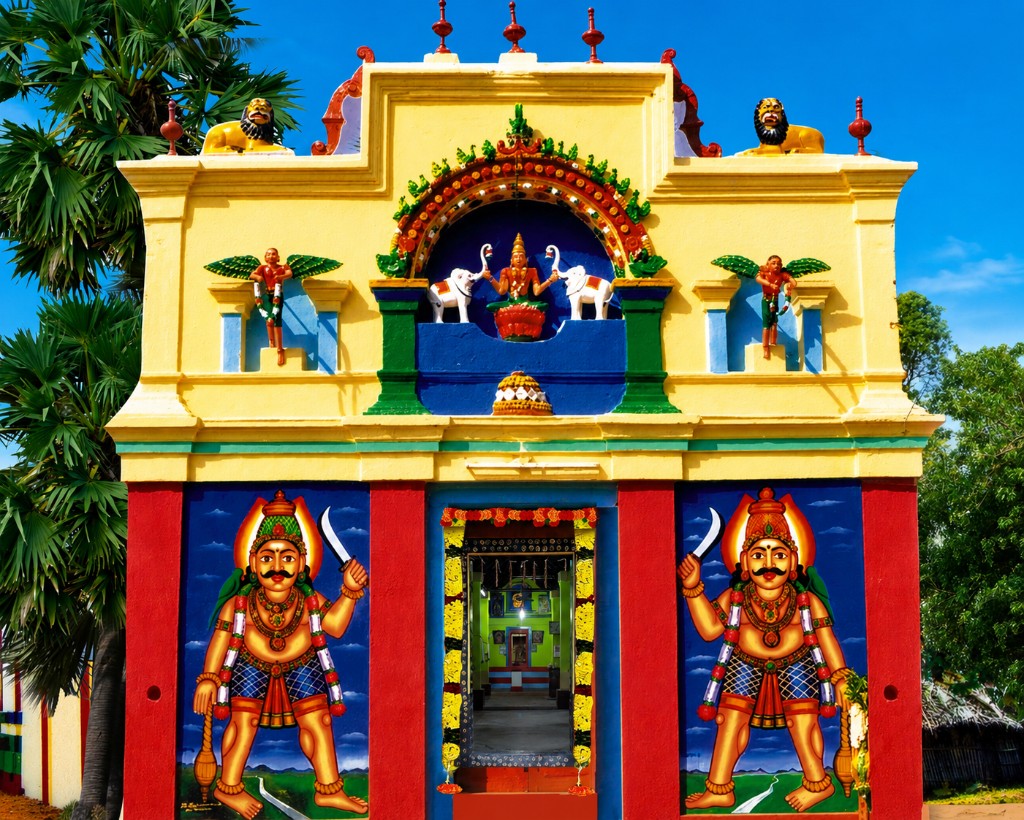 Colorful South Indian temple entrance with guardian deities and ornate gopuram